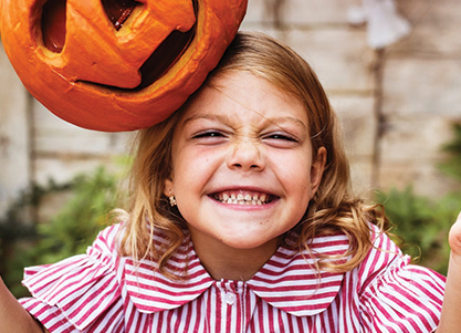 Little girl smiling widely at the camera